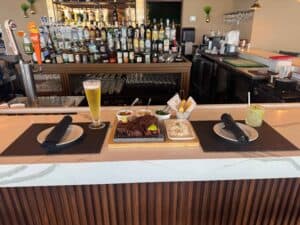 A Brazilian-style Picanha steak on a stone board, served at a bar with beer and cocktails at this steakhouse near Disney World
